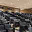 Large classroom with black chairs, tiered